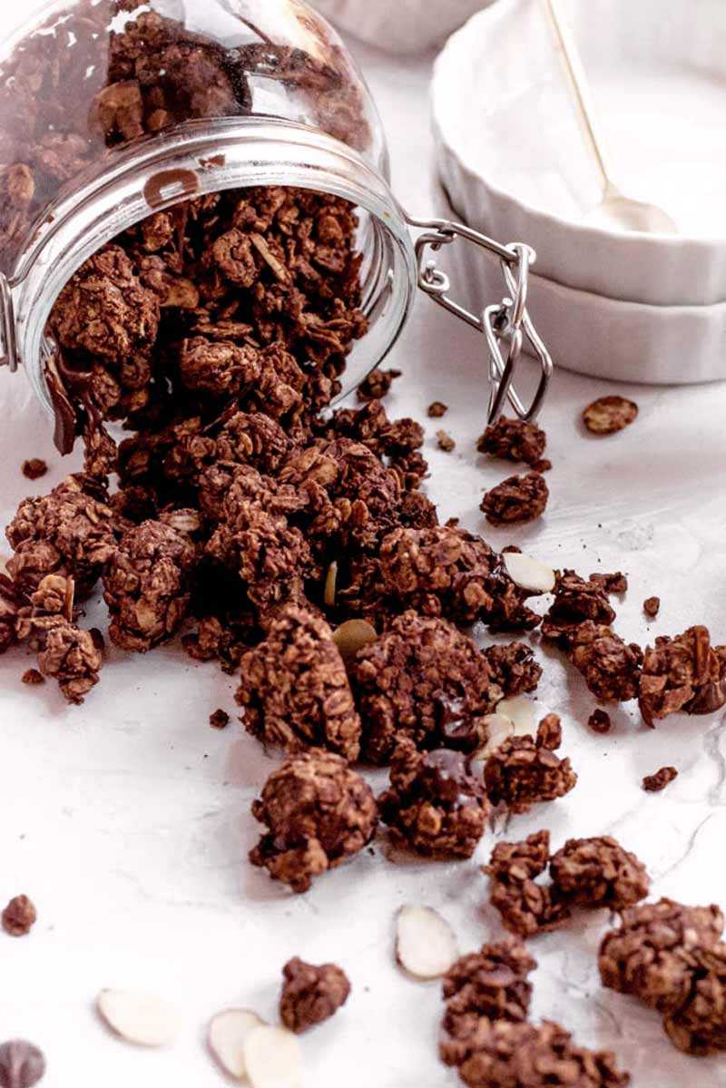 the dark chocolate granola spilling out of a glass jar.