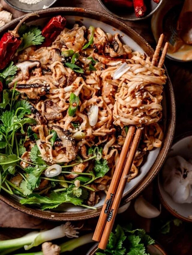 creamy miso noodles in a bowl with chopsticks.