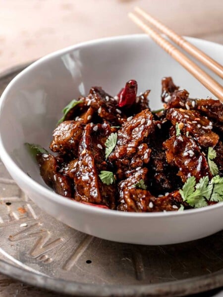 a bowl of easy vegan seitan strips with sesame sauce and cilantro.
