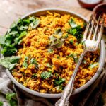 a bowl of yellow jasmine rice seasoned with Indian inspired spices.
