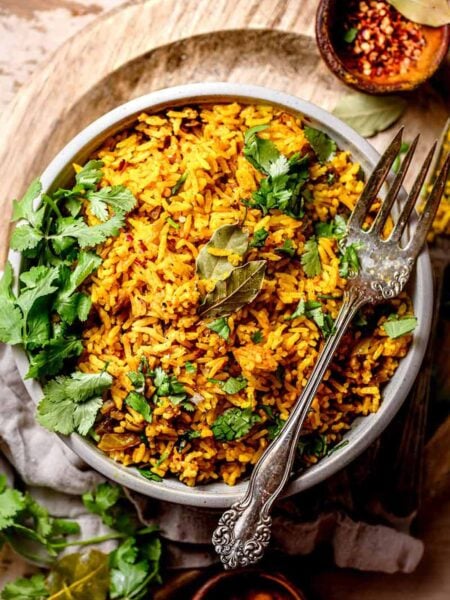 easy yellow jasmine rice in grey bowl with a silver vintage fork.