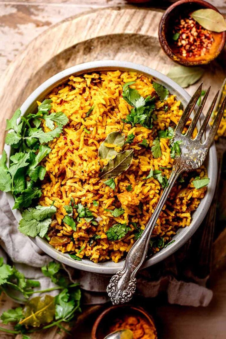 easy yellow jasmine rice in grey bowl with a silver vintage fork.