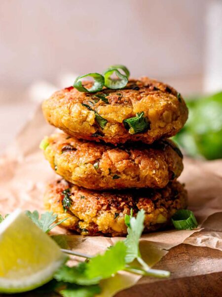a stack of vegan chickpea patties with green onion.