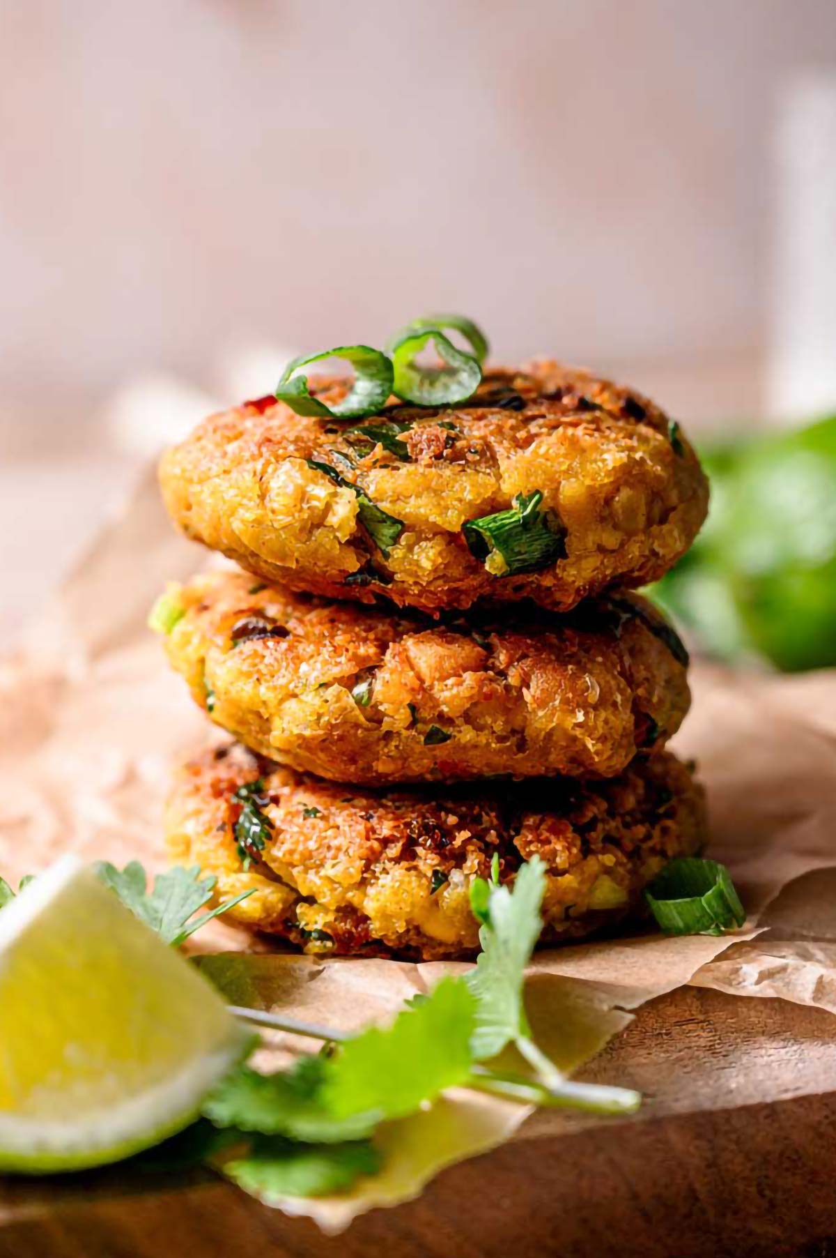 a stack of vegan chickpea patties with green onion.