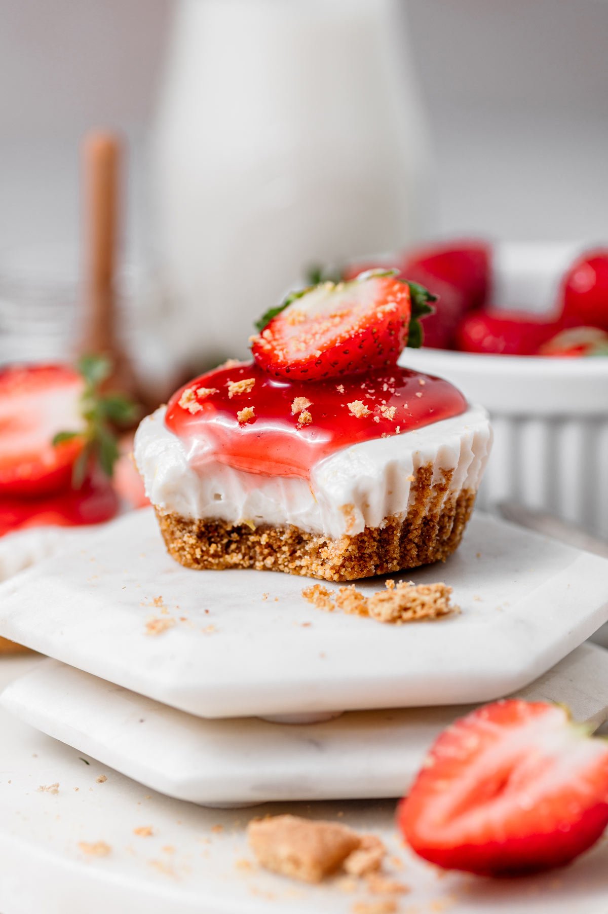 vegan mini no bake cheesecake on a white marble coaster.