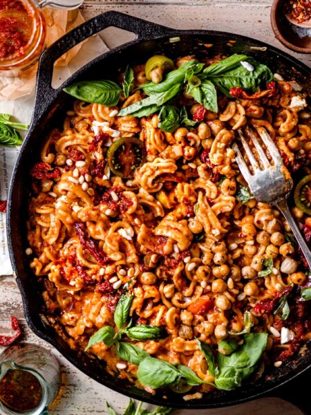 sun-dried tomato pesto pasta in a cast iron pan.