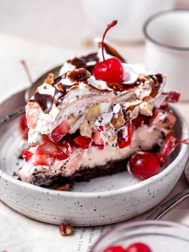 a slice of banana split pie in a small ceramic plate.