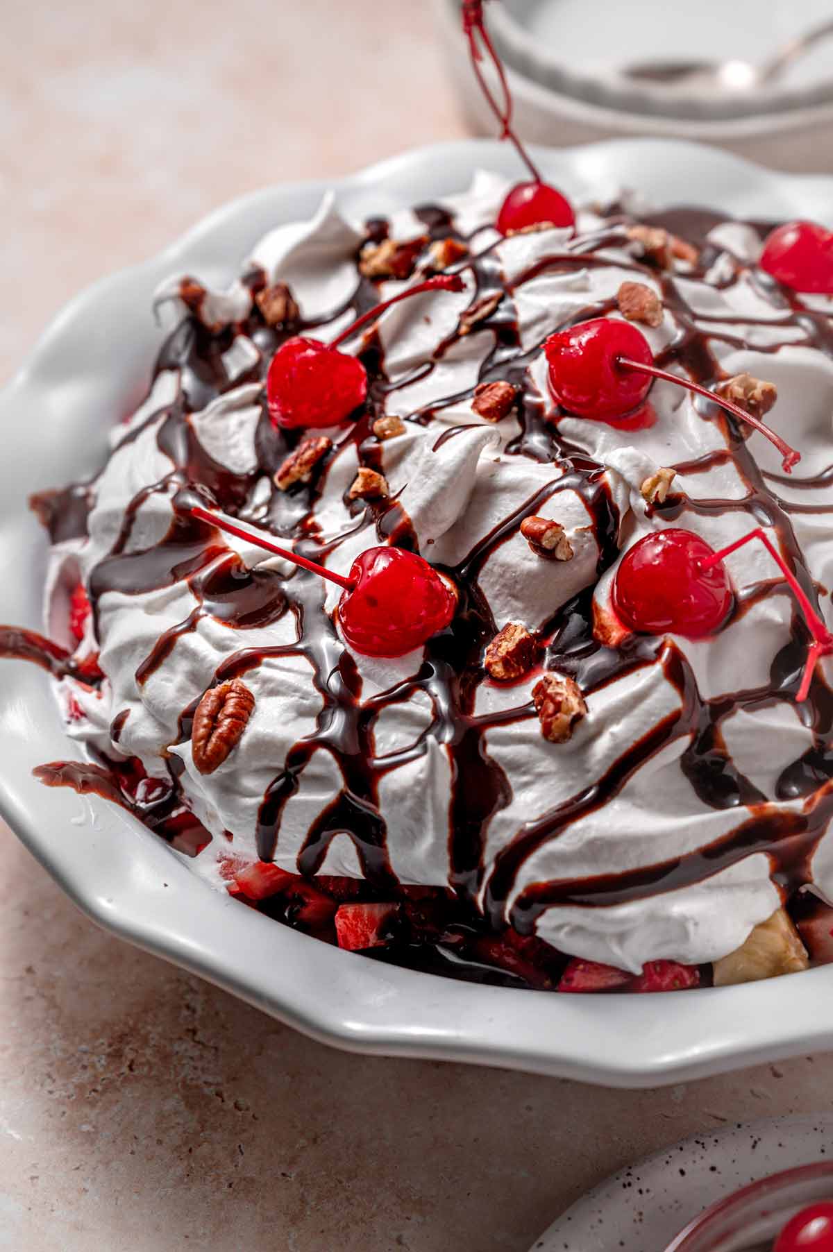 the decorated cool whip with cherries and chocolate fudge syrup.