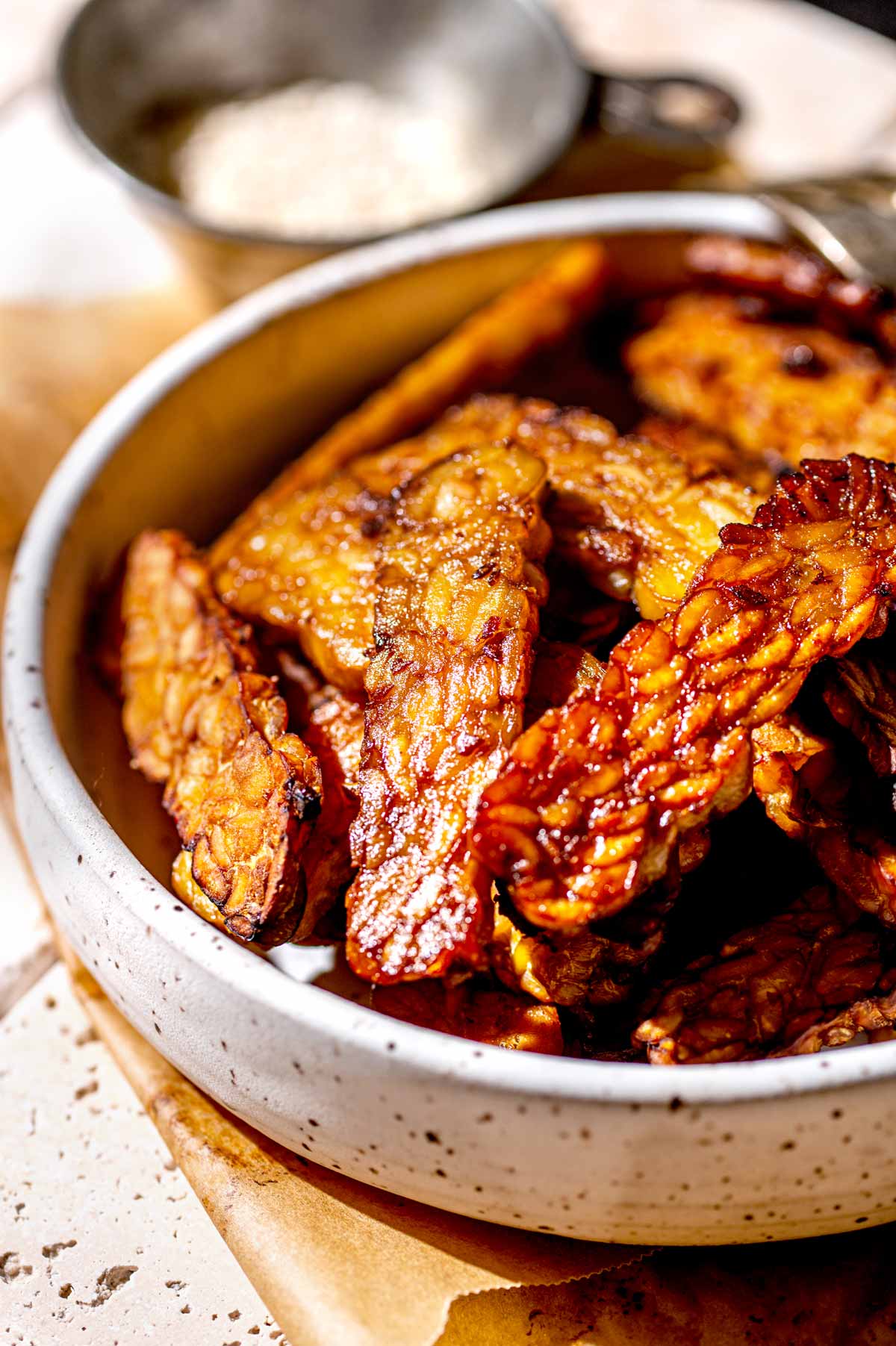 crispy tempeh in a white bowl.