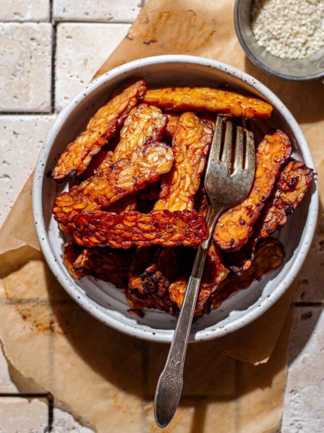 pan fried tempeh in a small white bowl.