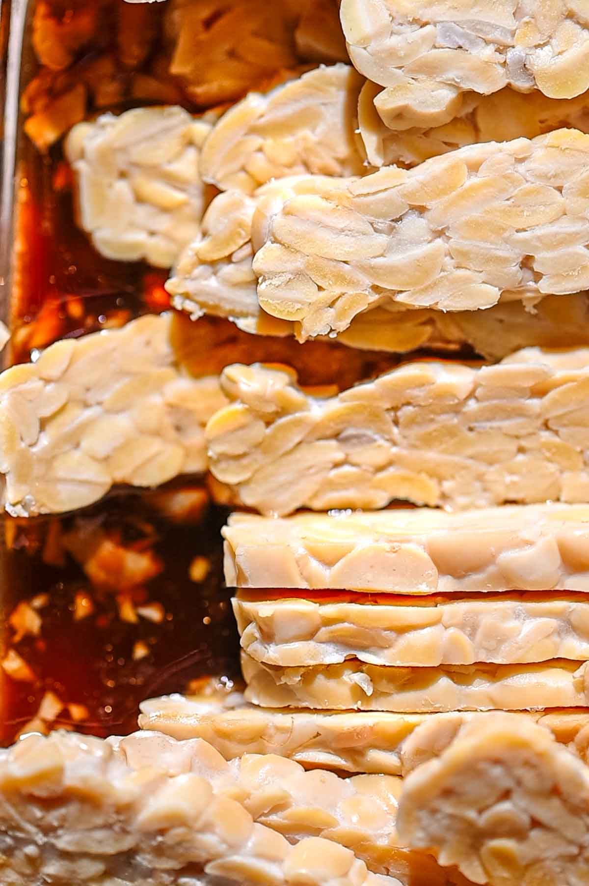 slices of tempeh in the marinade.