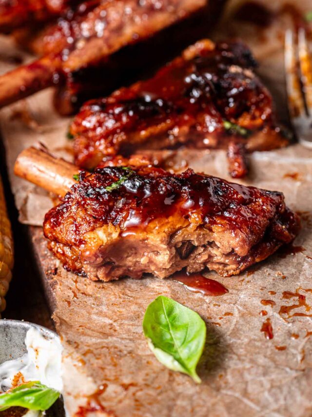 vegan ribs on parchment paper with bbq sauce.