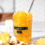 a mason jar with homemade pineapple jam inside.
