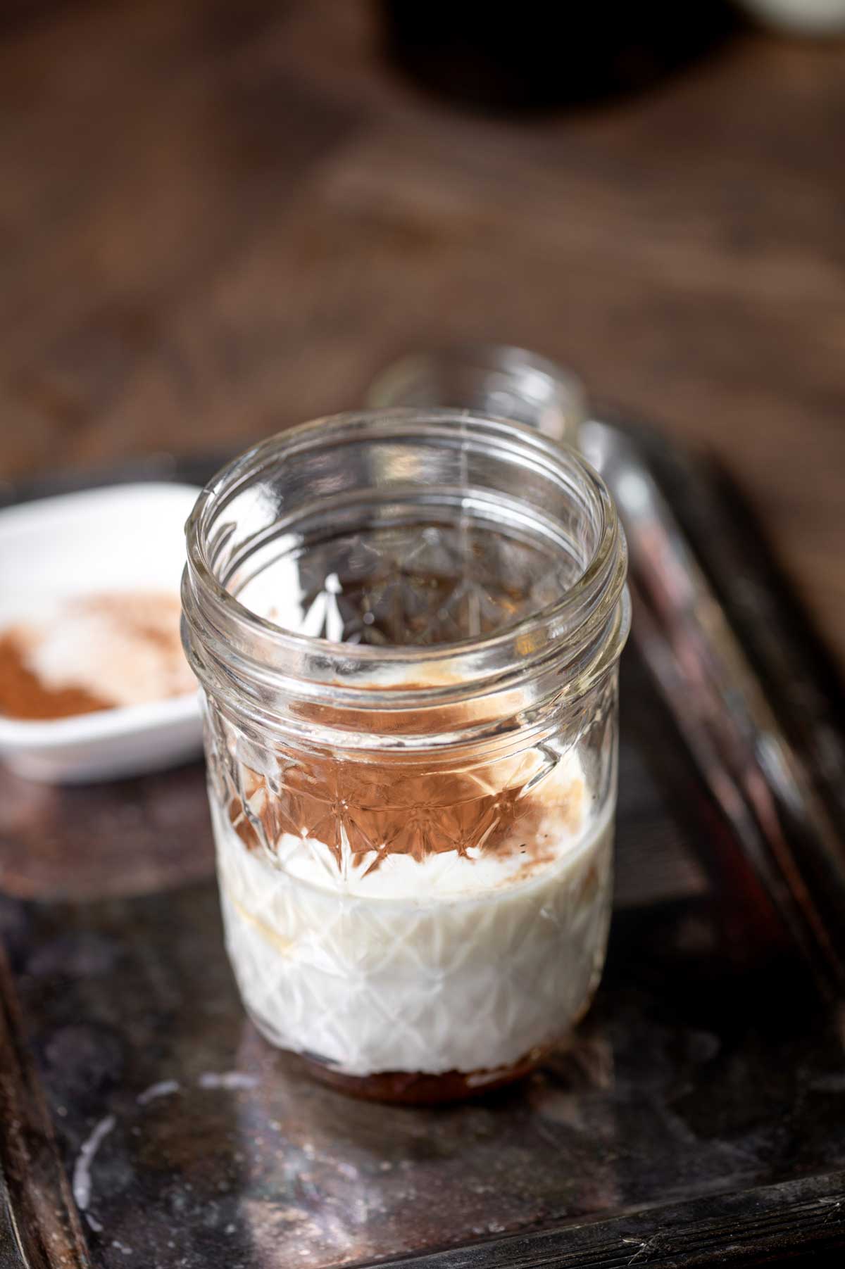 a small glass jar with coconut cream and pumpkin pie spice for dairy free sweet cream.