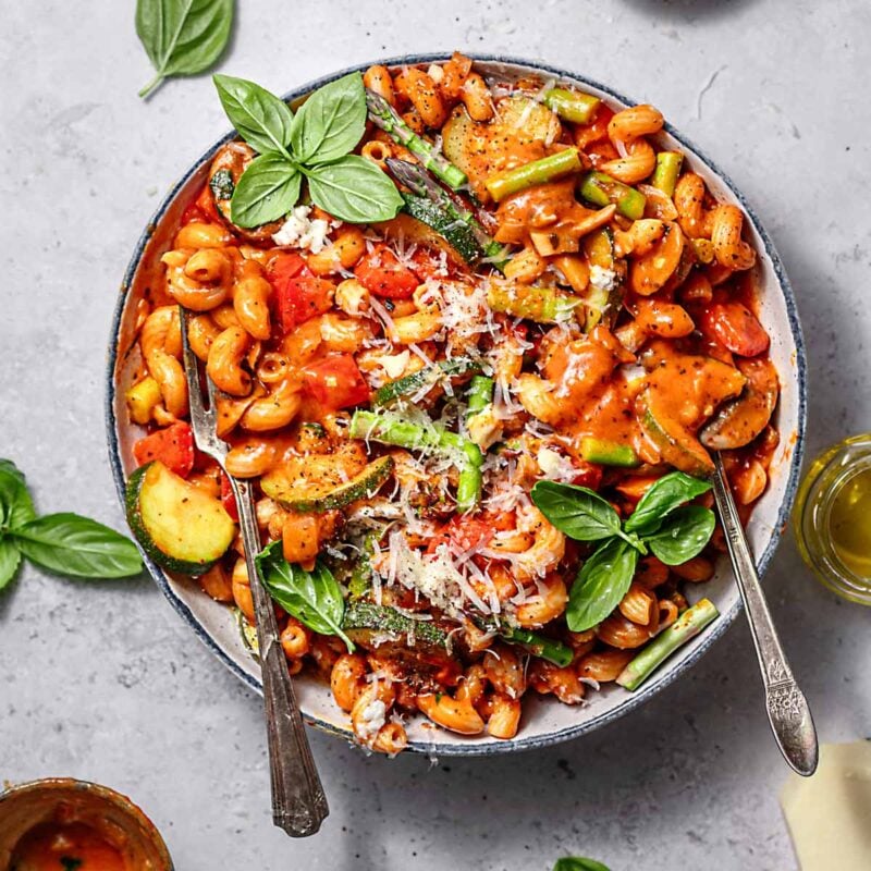 one pot vegetable pasta with creamy tomato basil sauce on top.
