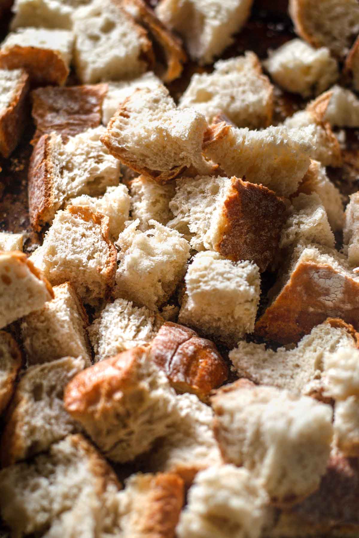 day old cubed bread on a tray.