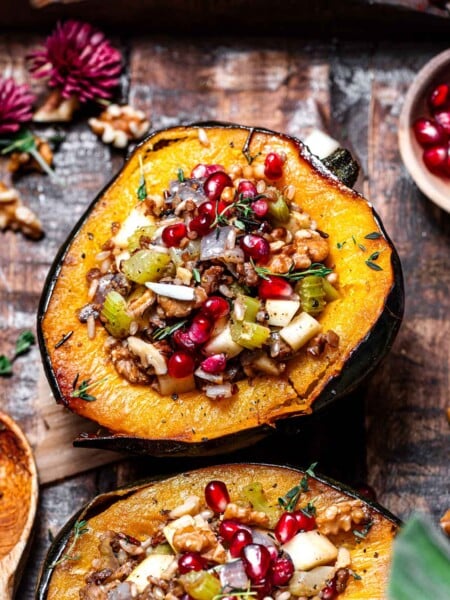 vegan stuffed acorn squash with wild rice and pomegranates.