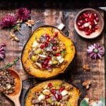 vegan stuffed acorn squash with wild rice and pomegranates.