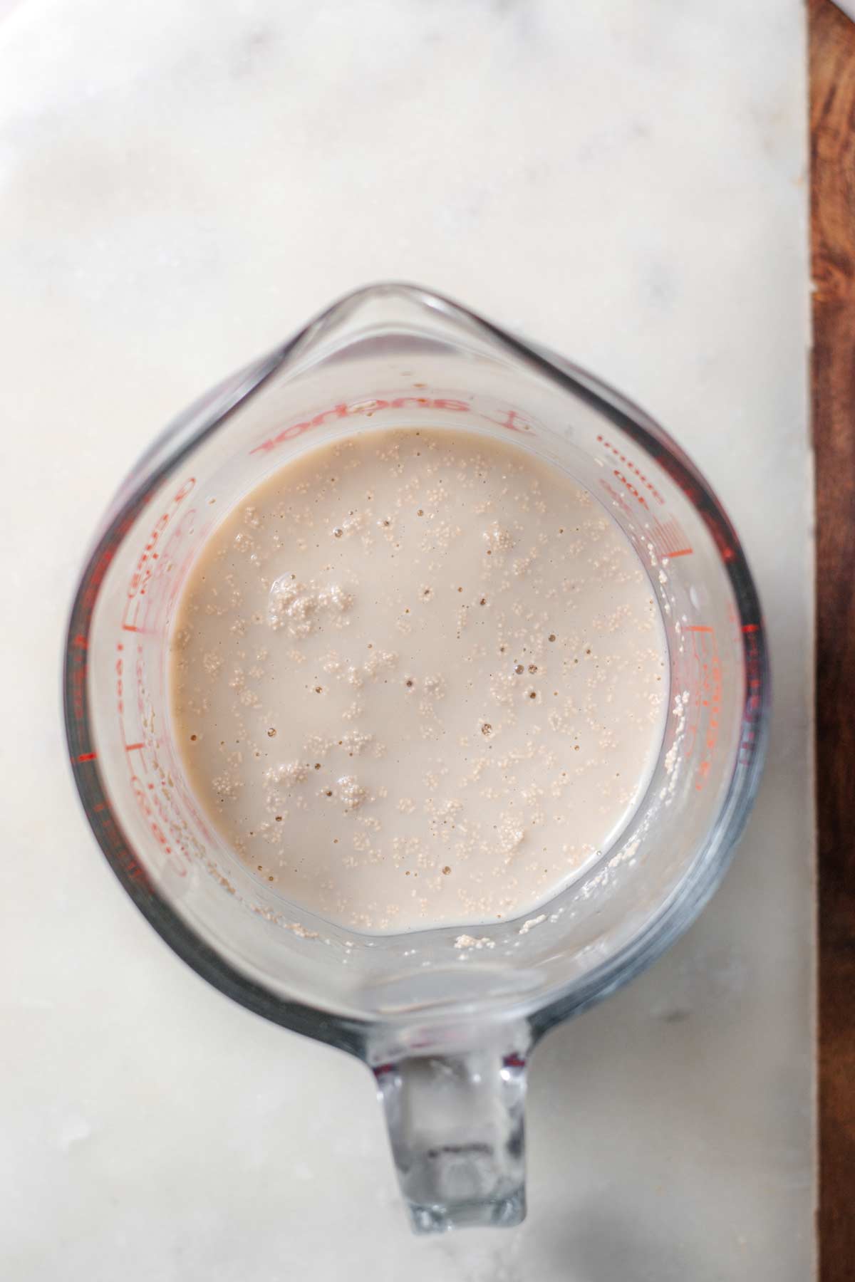 active dry yeast activating in a measuring cup.