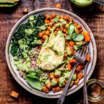 vegan chickpea sweet potato buddha bowl with green goddess dressing on top.