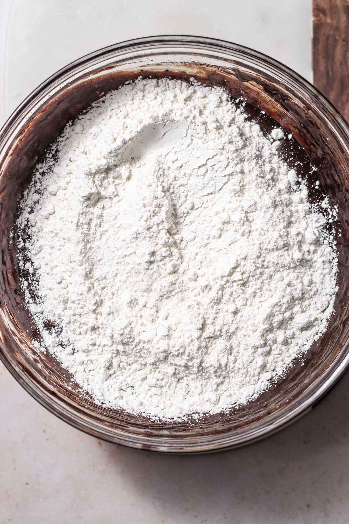 dry ingredients for vegan brownies on the whisked chocolate and sugar.