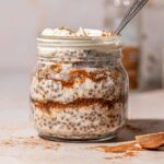 a small jar with cinnamon overnight oats topped with vegan yogurt.