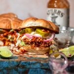 a BBQ tofu sandwich with pickled onions and smashed avocado.