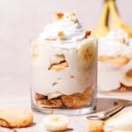 a glass cup filled with vegan banana pudding.