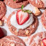 strawberry crunch sugar cookie with whipped cream and a strawberry on top.