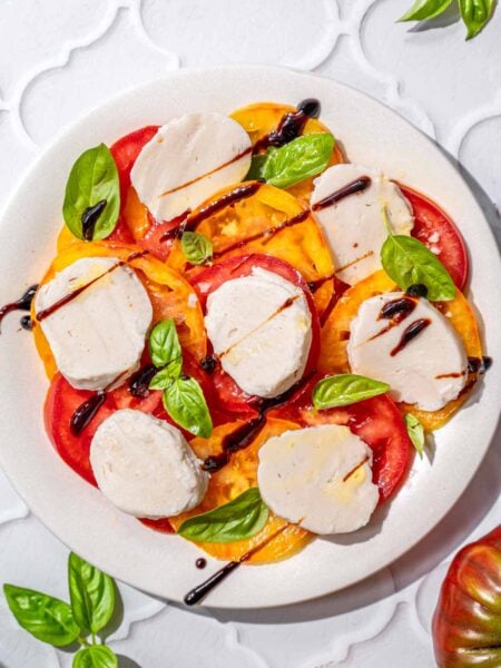 a top view of a vegan caprese salad with heirloom tomatoes.