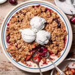 vegan cherry apple crisp with dairy free vanilla ice cream on top.