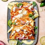 crispy black bean tacos with cilantro sauce on top.