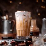 an iced pecan crunch oatmilk latte with cold foam.