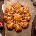 vegan apple star bread on parchment paper.