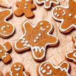 vegan gingerbread cutout cookies on brown parchment paper.