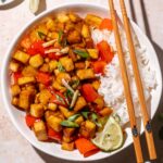 sticky sesame ginger tofu in a bowl with rice.
