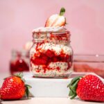 a small jar filled with strawberry and cream overnight oats.
