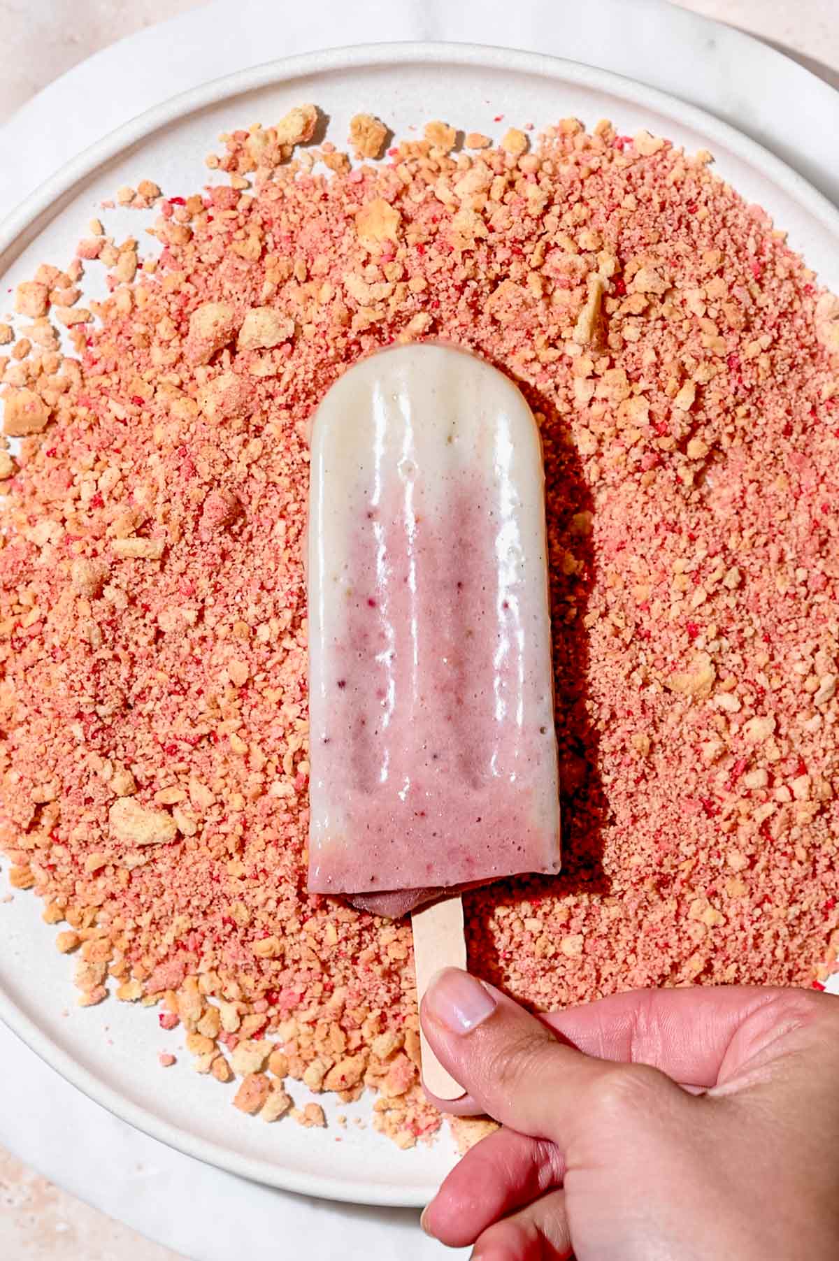 an ice cream bar on a plate with crumble. 