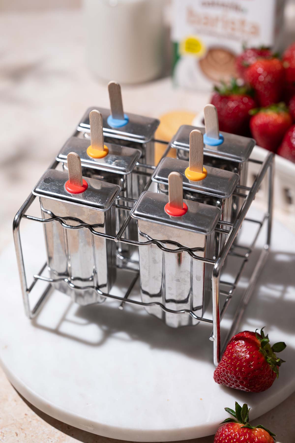 the strawberry shortcake ice cream bars in a metal popsicle mold.