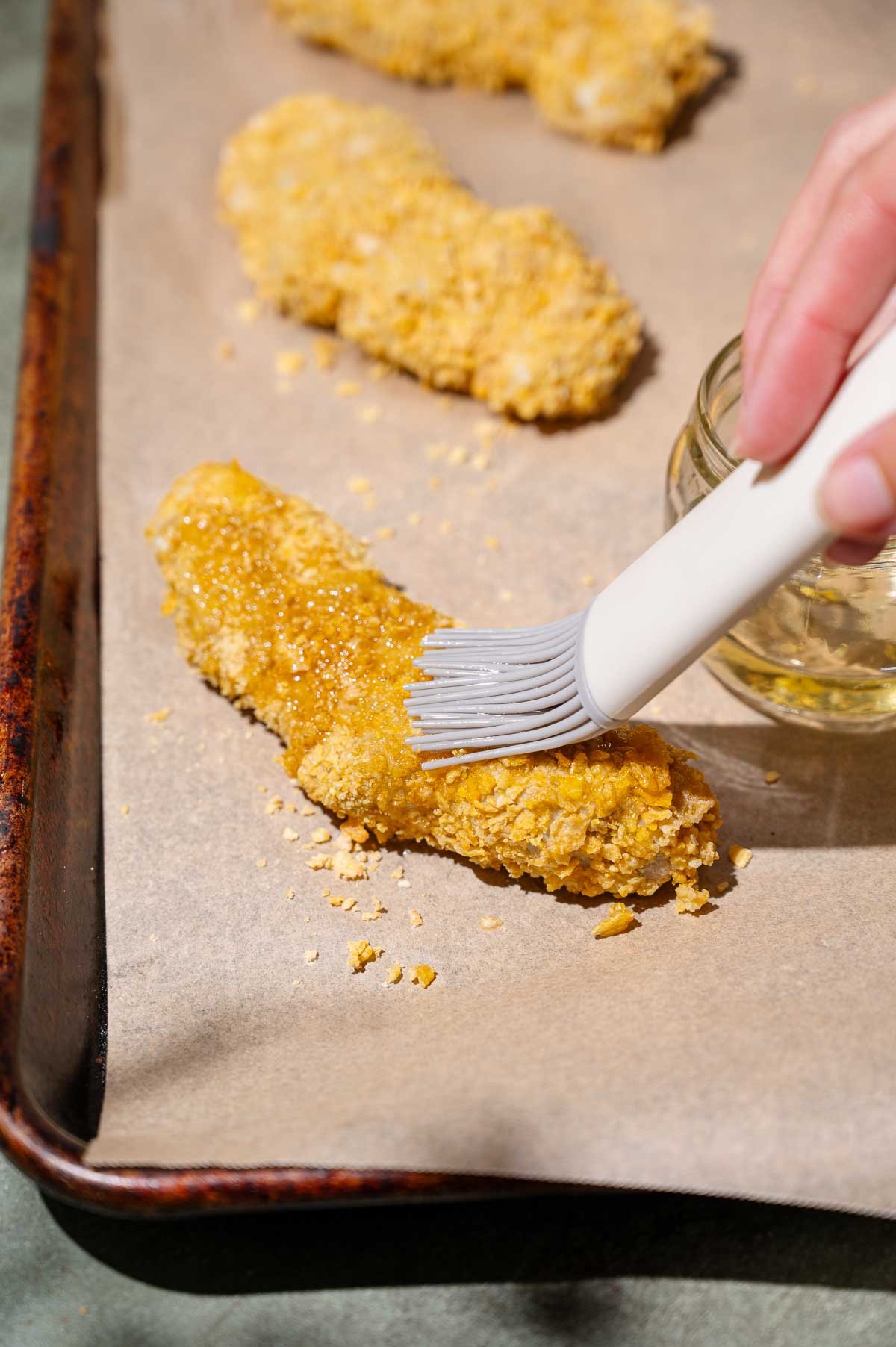 the vegan buffalo chicken being coated in oil.