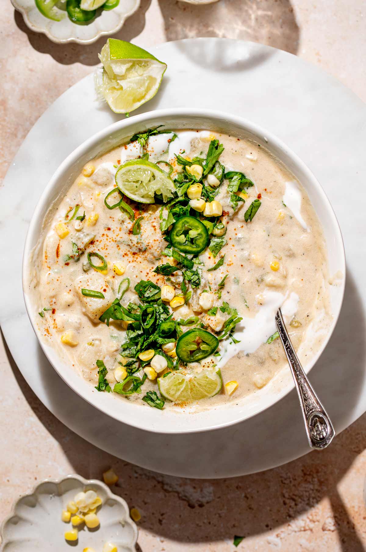 a bowl of vegan corn chowder with potatoes, cilantro and cashew cream.