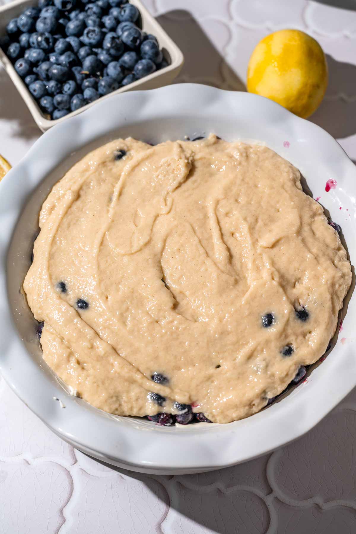 the cobbler batter on the prepped berries before baking.