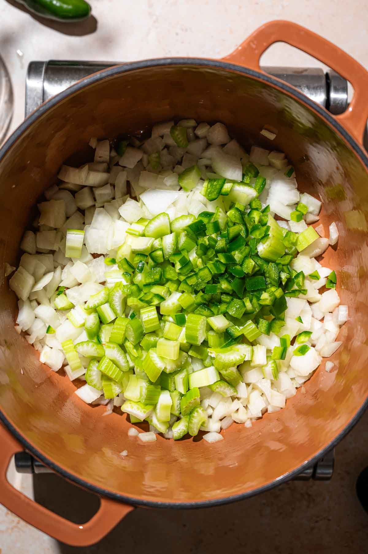 celery and jalapeno in a pot with onions.