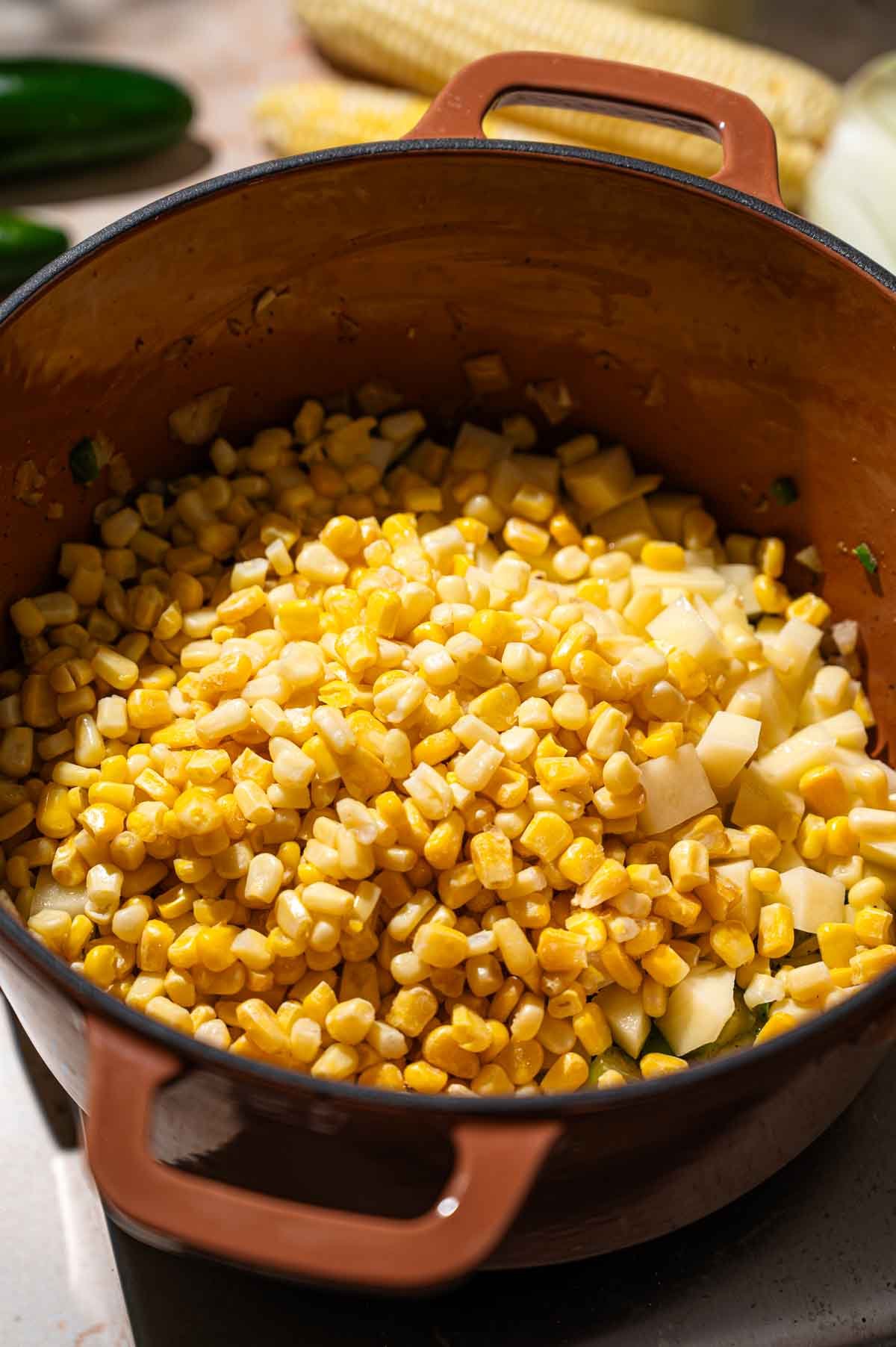 corn and potatoes in a dutch oven.