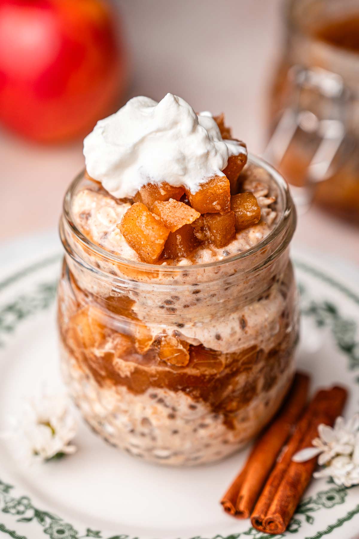 a jar of apple pie overnight oats with whipped topping.