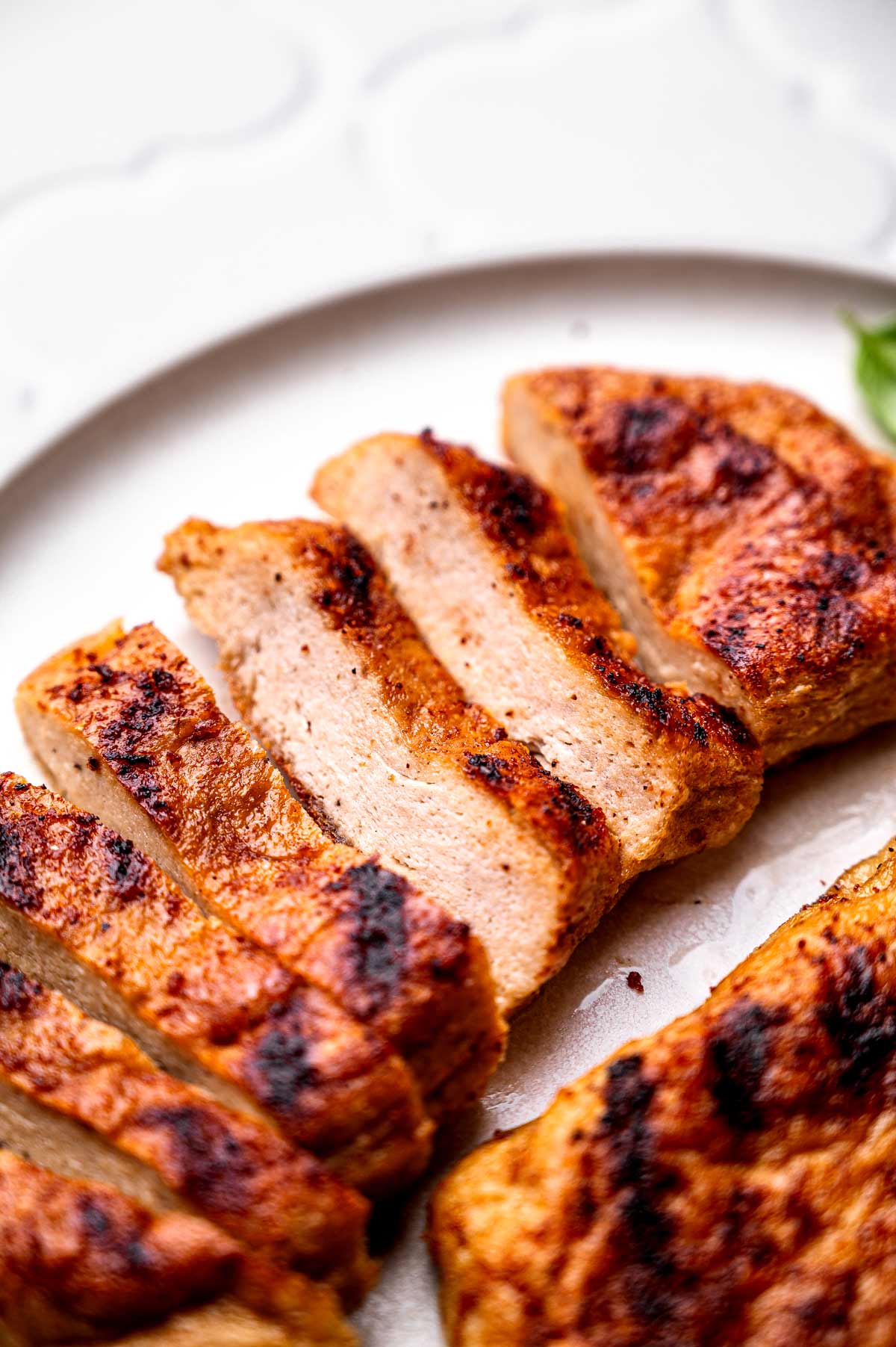 sliced vegan chicken pieces on a plate.