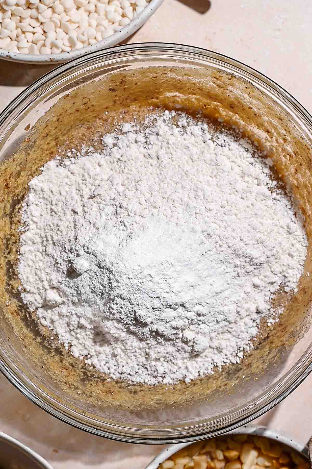 dry ingredients on the whisked wet ingredients for the eggless blondies.