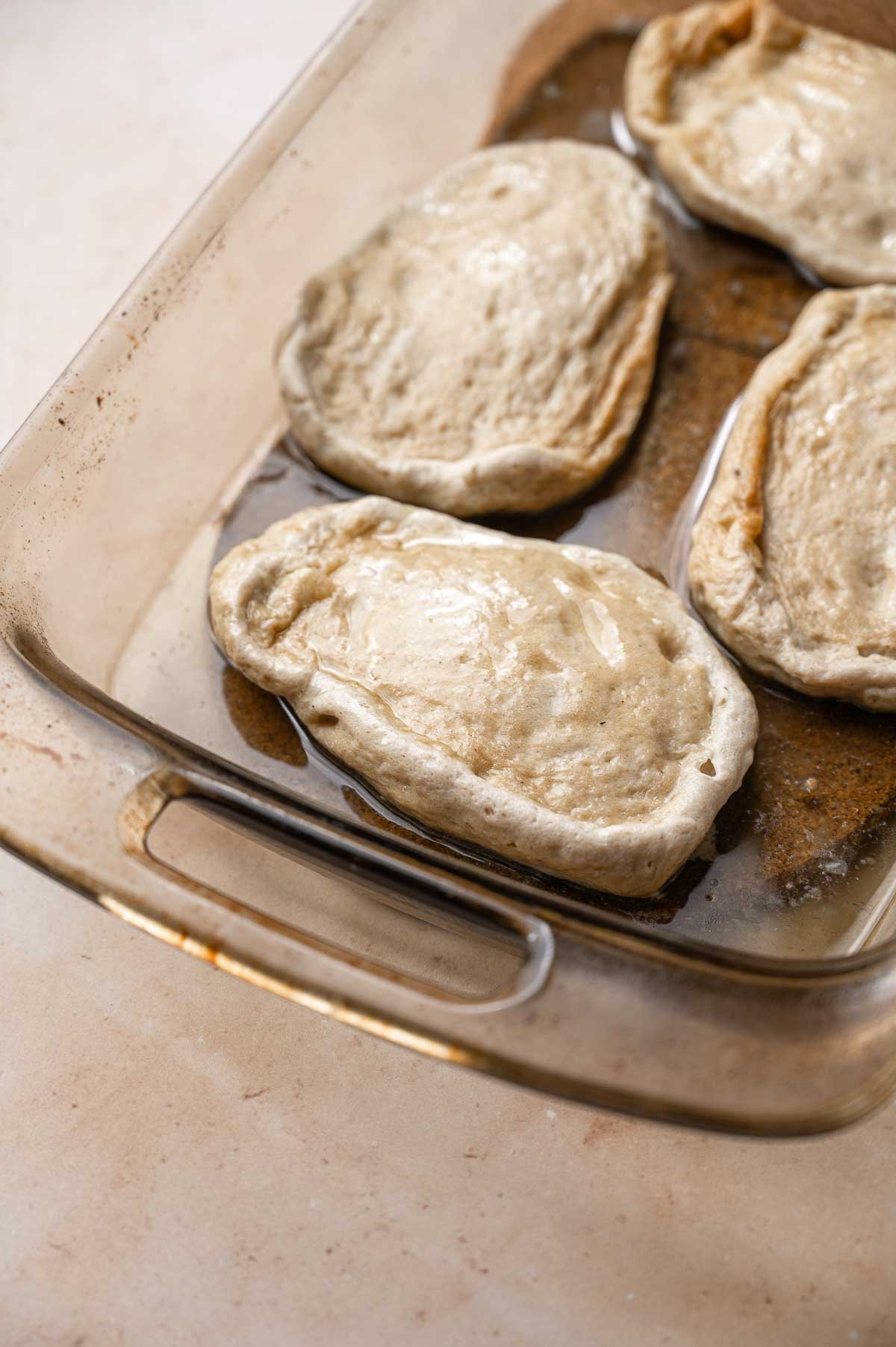 the vegan chicken breasts in a pan after baking for half the time.