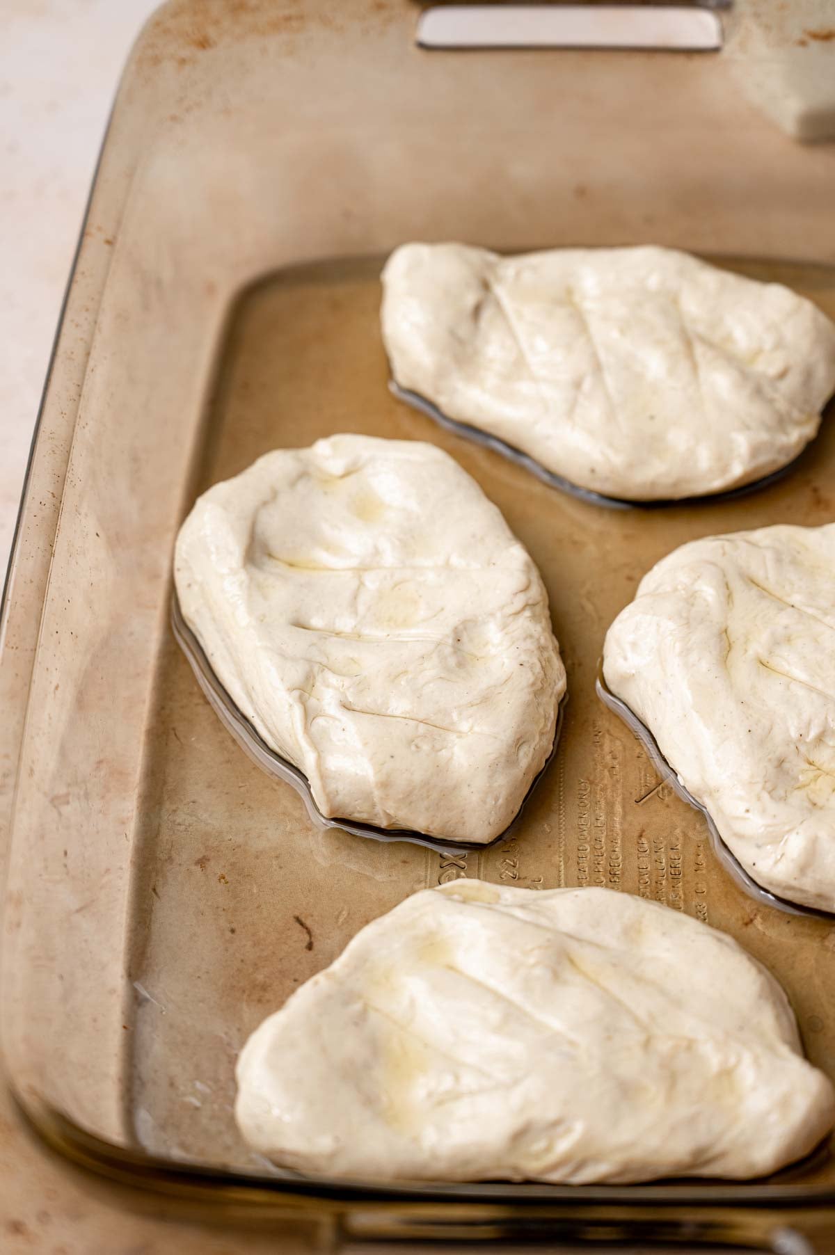 the seitan vegan chicken breasts in a baking pan.