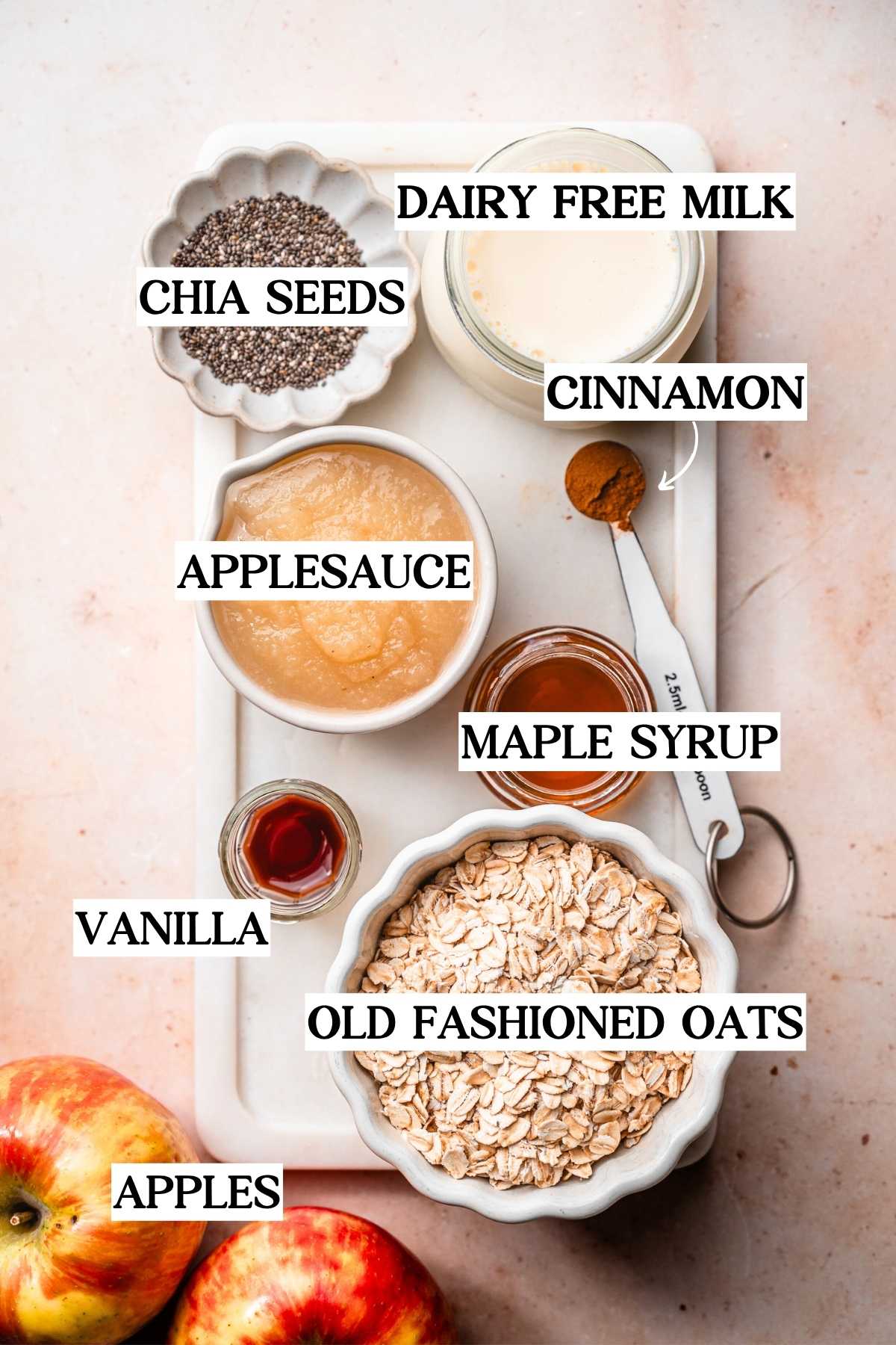 ingredients like applesauce, old fashioned oats, soy milk and chia seeds on a white marble tray.